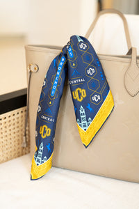UCO scarf tied on tan bag