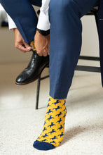 Load image into Gallery viewer, UCO gold and navy broncho sock. man tying black dress shoe
