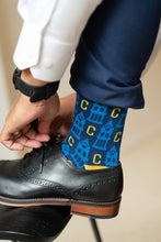 Load image into Gallery viewer, man tying shoe with UCO sock on

