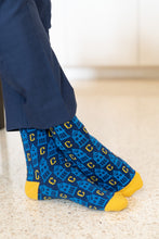 Load image into Gallery viewer, man resting feet after work. Blue old north and gold C sock
